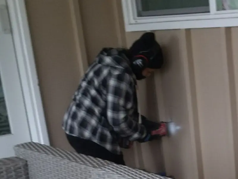 Professional electrician installing an exterior outlet in Evanston